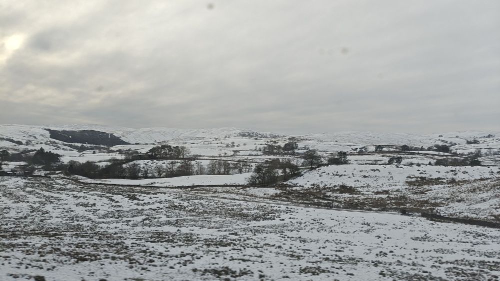 Photo of snowy fields and hills 