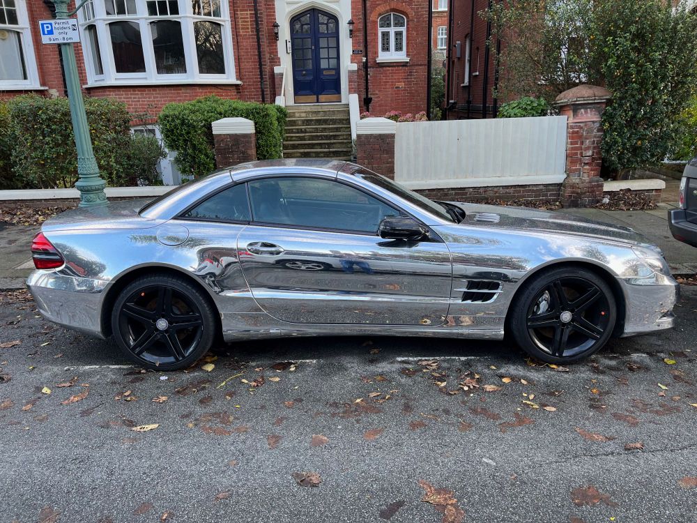 A parked silvery sporty car