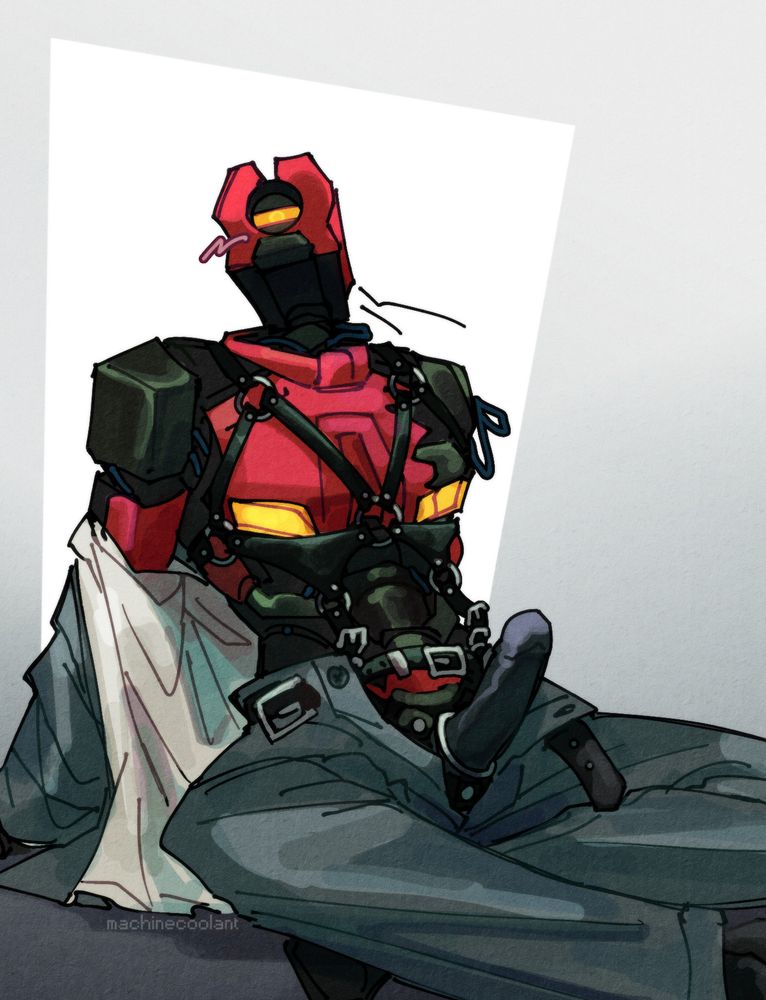 v2 sitting half clothed revealing it's wearing a harness and a fairly large strap on dildo