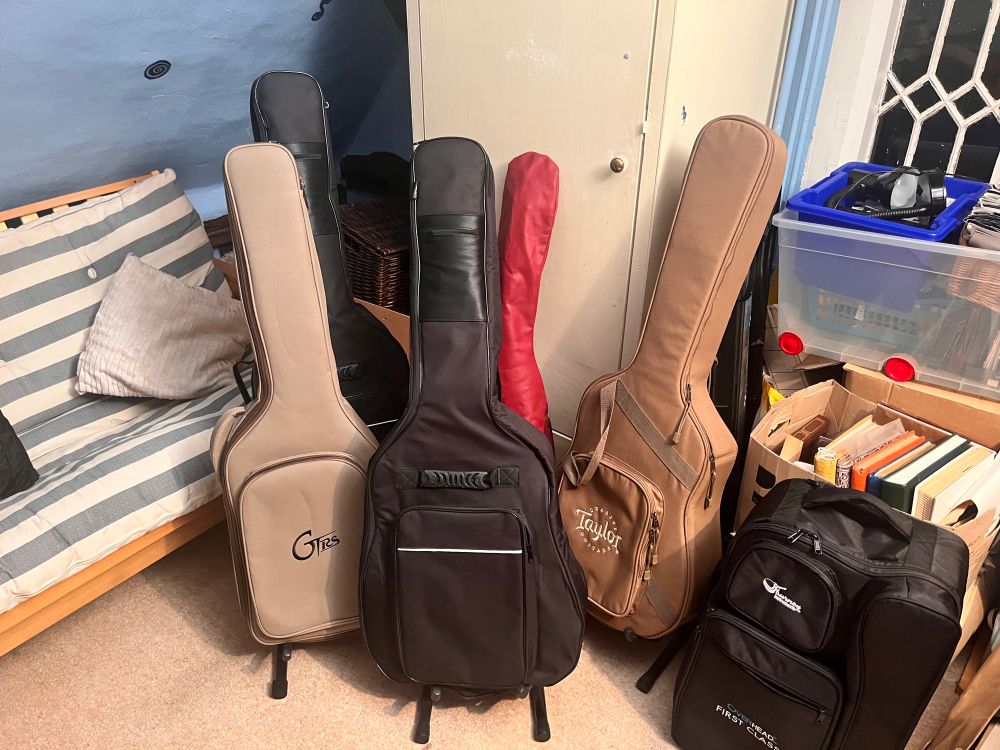 A collection of guitars in cases