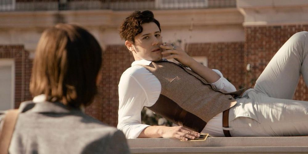 Elliot, from the magicians, reclining outside in a waistcoat, cream pants and white shirt