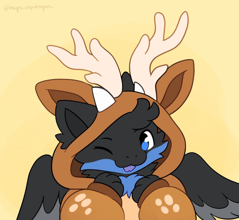 A black fluffy dragon with a blue underbelly. They are sticking a forked purple tongue out and wearing a Deer Kigu (Kigu is an animal themed onesie)