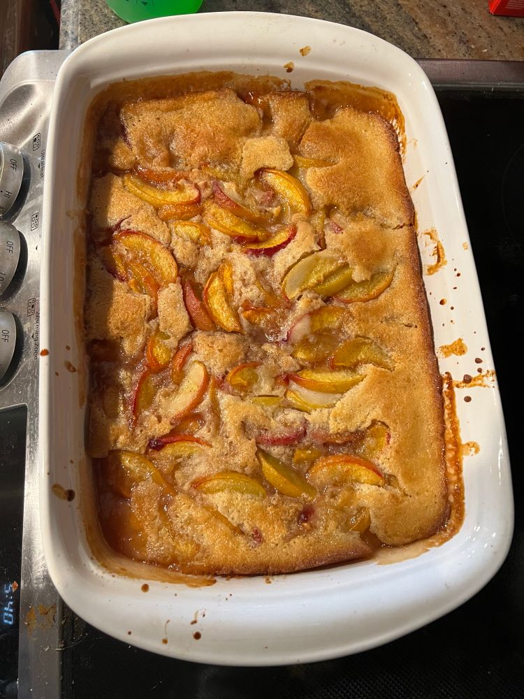 A dish of freshly baked peach cobbler 
