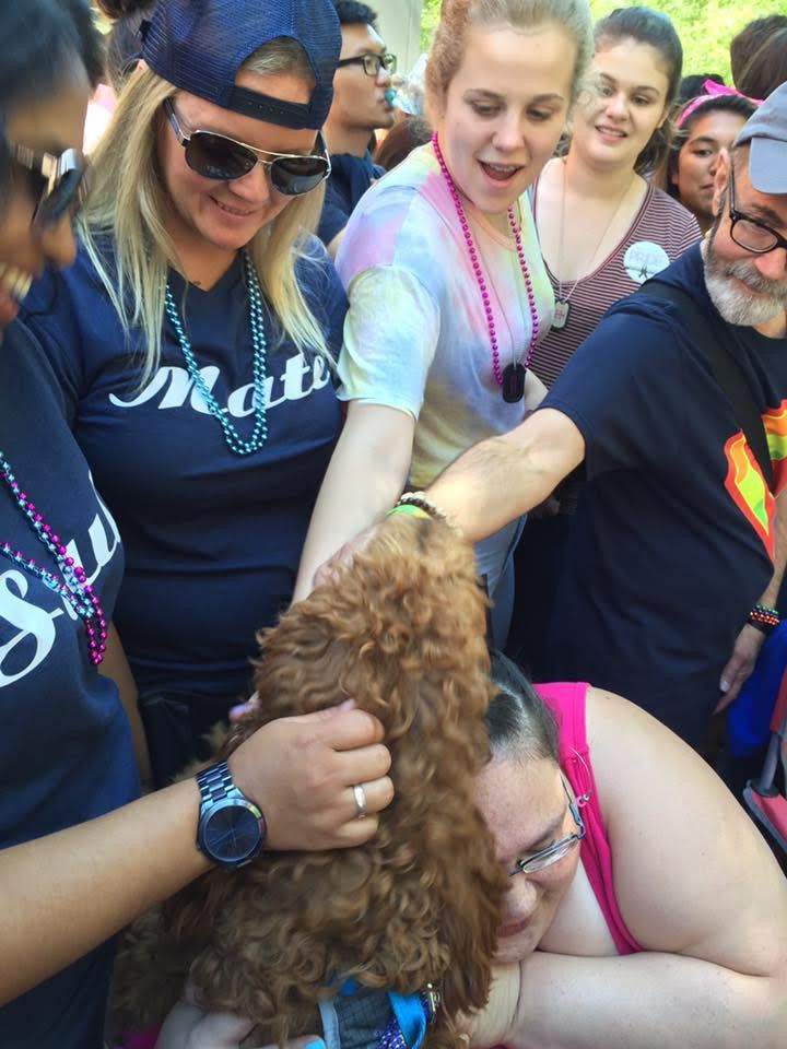 Ori crowd-surfing at Pride and giving everyone hugs.