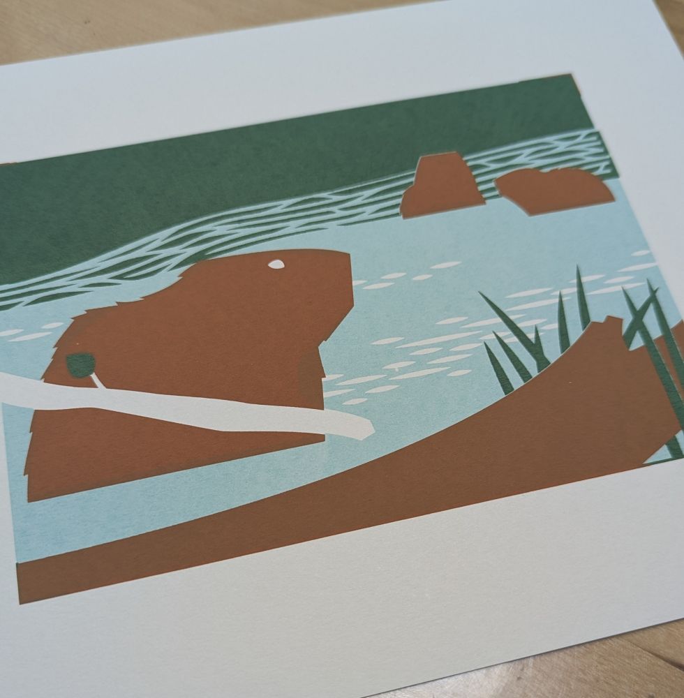 A screen print with layers of light blue, green, and warm brown in the vague shape of three beavers, foliage, and a fallen tree