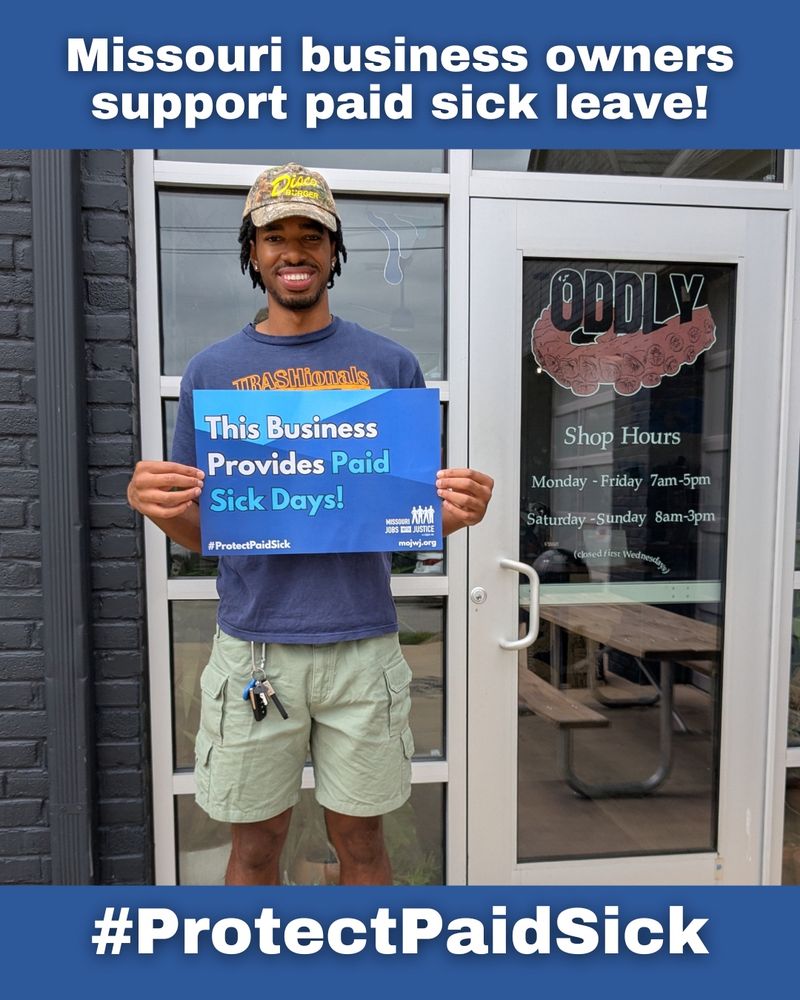  A smiling person stands outside Oddly Correct a coffee shop in KC, holding a blue sign that says “This Business Provides Paid Sick Days!” The caption above reads “Missouri business owners support paid sick leave!” At the bottom, the hashtag #ProtectPaidSick is displayed.