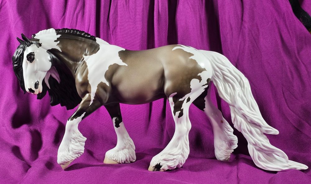 A photo of the left side of Stone model horse Cthulhu, on the Irish cob mold. He is a grulla tobiano; the white on his shoulders looks like wings while is neck, legs, and haunches appear to have tentacles.