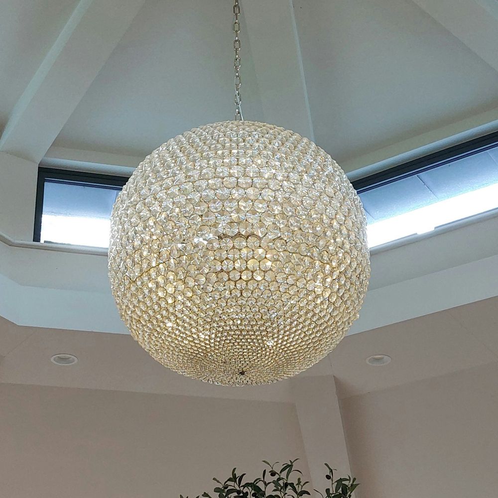 Beautiful lighting in the Orangery at The Inn on the Lake, Ullswater, Lake District, UK.

Very large chandelier crystal ball light made up of hundreds of crystals.