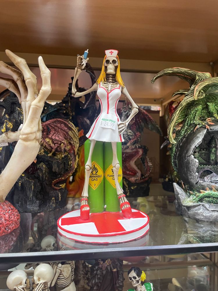 a statuette of the nurse from the blink-182 album cover, except she’s also a skeleton