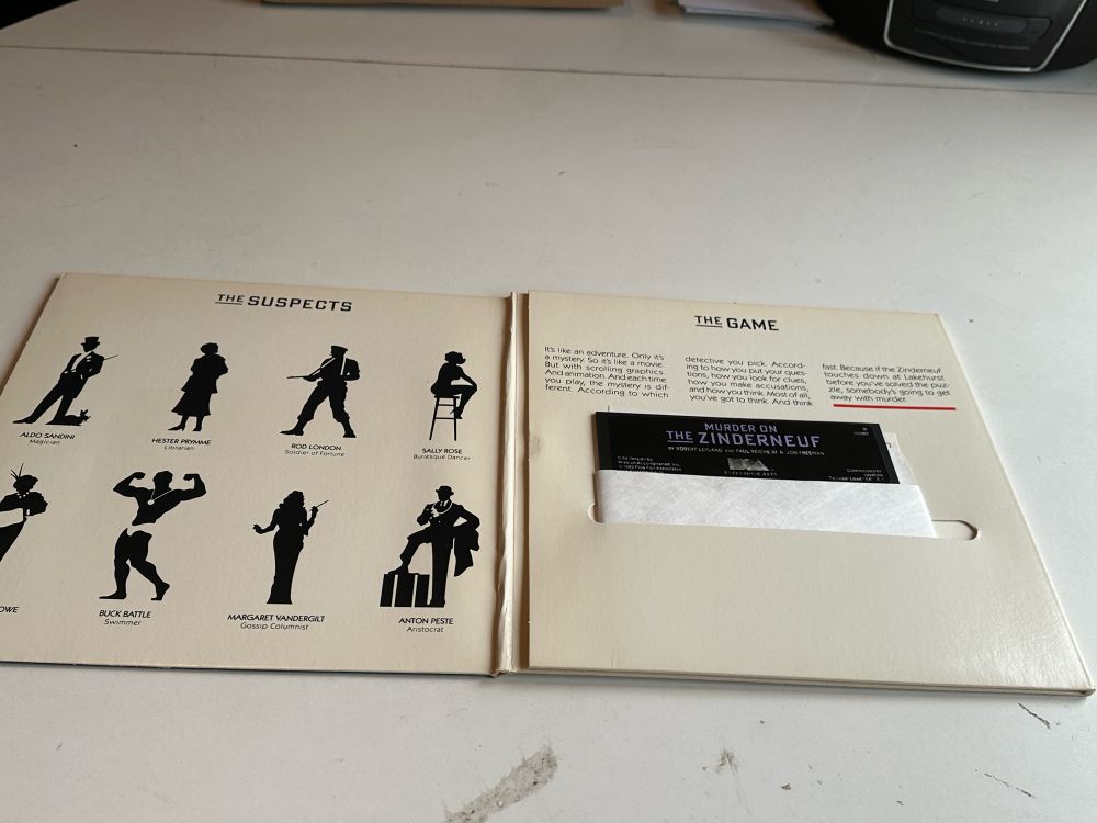 Inside the Murder on the Zinderneuf gatefold cover - suspect silhouettes on the left, 5.25” floppy disk on the right