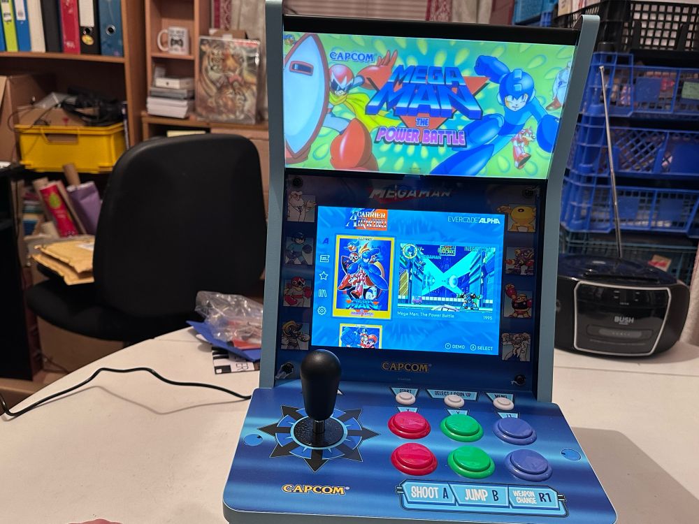 Evercade Alpha cabinet - blue miniature arcade cabinet with controls at the front (black joystick, six buttons)