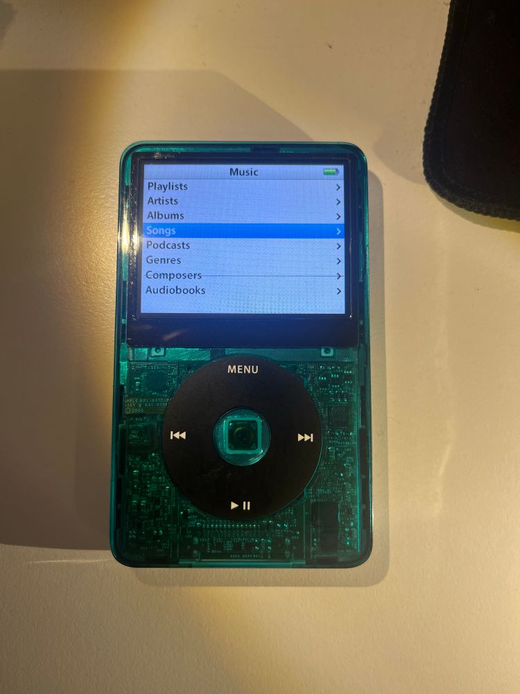 IPod classic with a translucent teal front panel and clock wheel centre button 