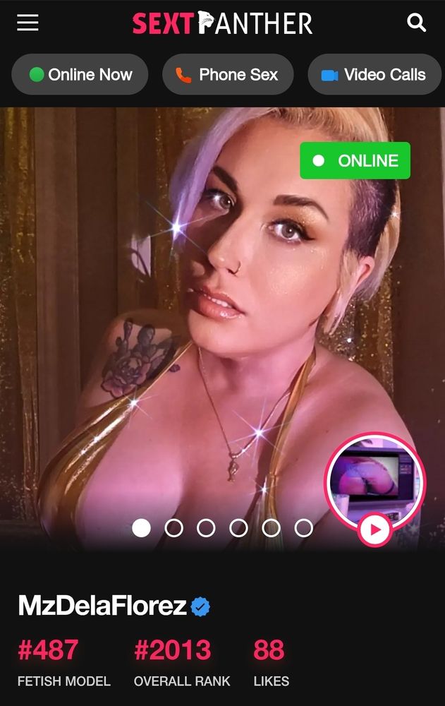 Screenshot of findom & femdom MILF Goddess, Mz Dela Florez 's SextPanther profile. She wears a sparkling metallic gold bikini with gold fabric draped behind Her. She makes seductively commanding eye contact, but inviting & daring you to message Her. 