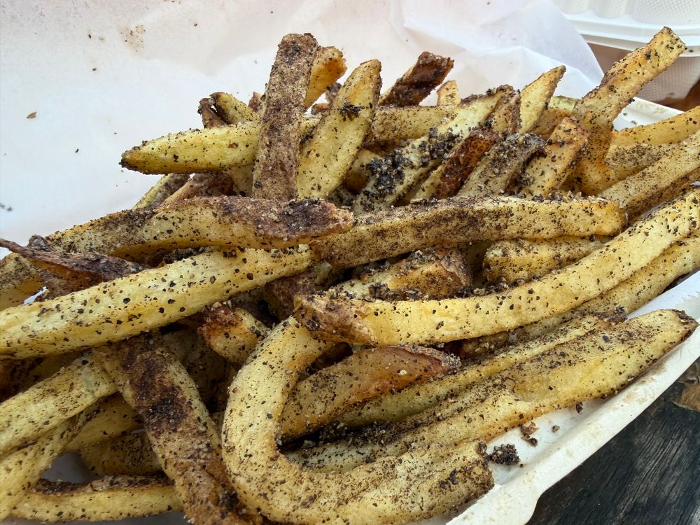 A bowl of fries absolutely coated in finely ground pepper. Take whatever amount of pepper you are thinking of and then quadruple it and then dump on another tablespoon 