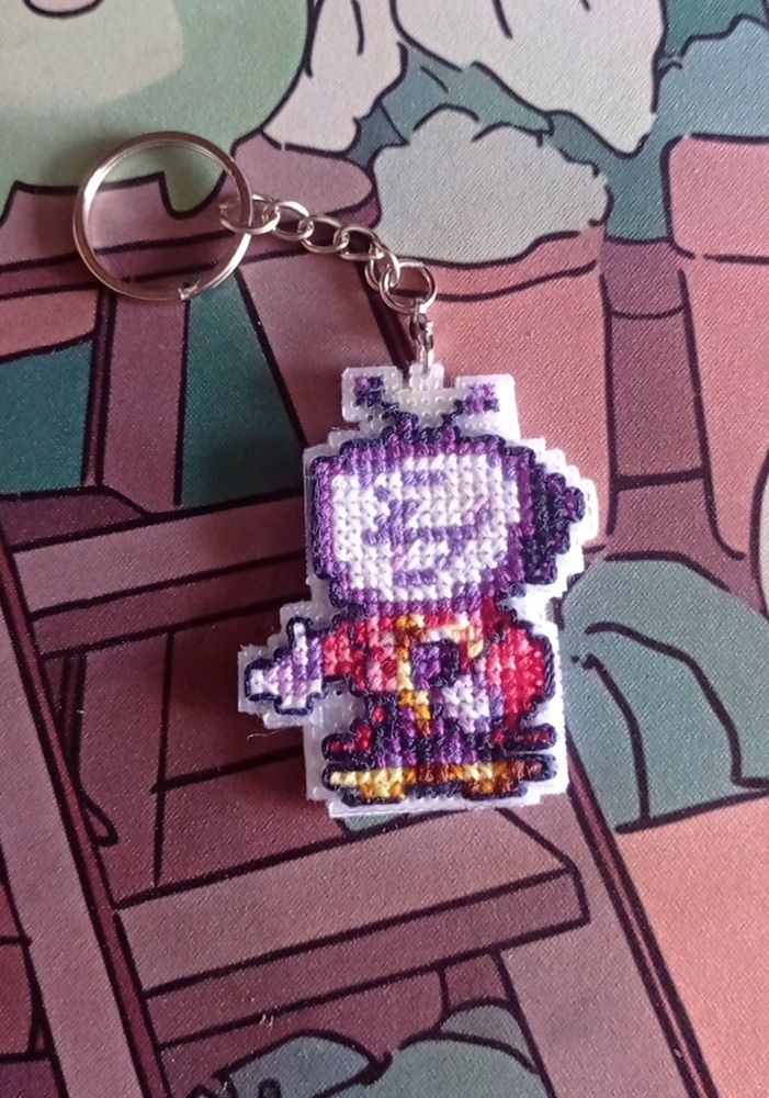 A cross-stitch keychain of chibi Tenna.