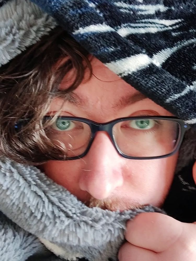 Me hiding under a pile of blankets 