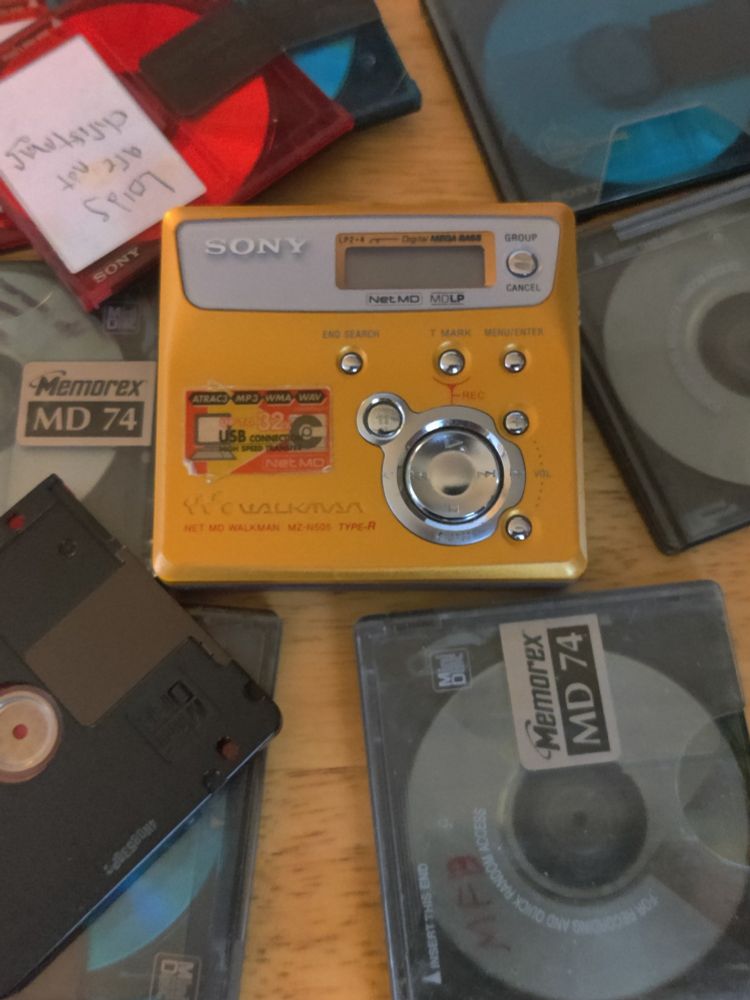 My minidisc player surrounded by a bunch of minidiscs 
