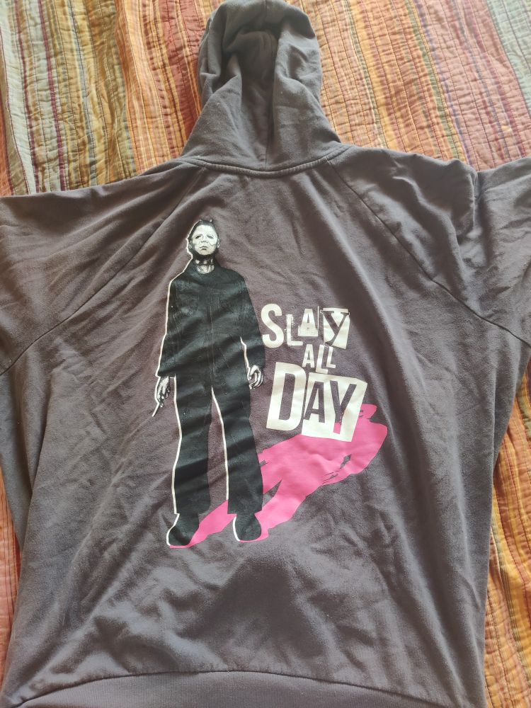 A Halloween hoodie featuring Michael Meyers with a caption saying "slay all day" 