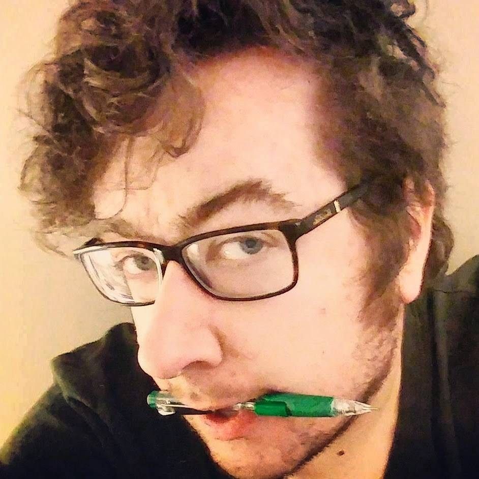 A selfie of me looking into the camera with a pencil in my mouth 
