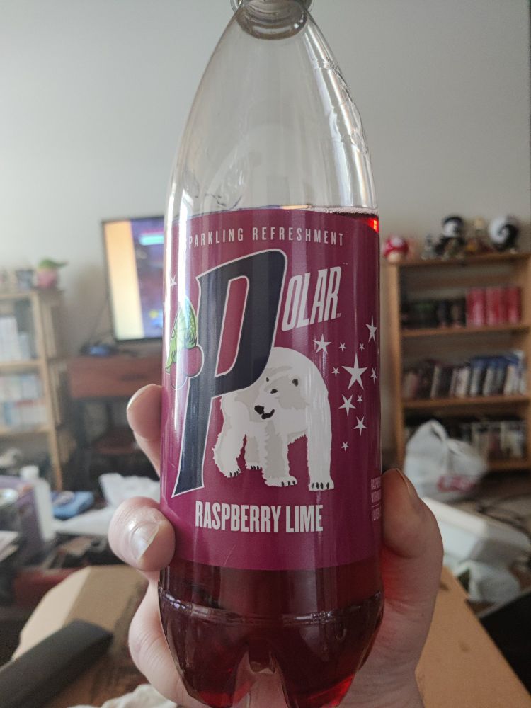 Me holding a bottle of Polar Raspberry Lime Soda 