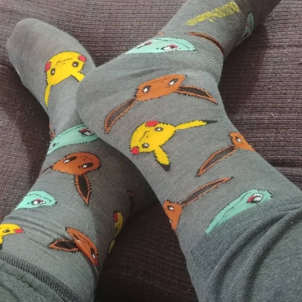 My feet In a pair of Pokémon socks. 