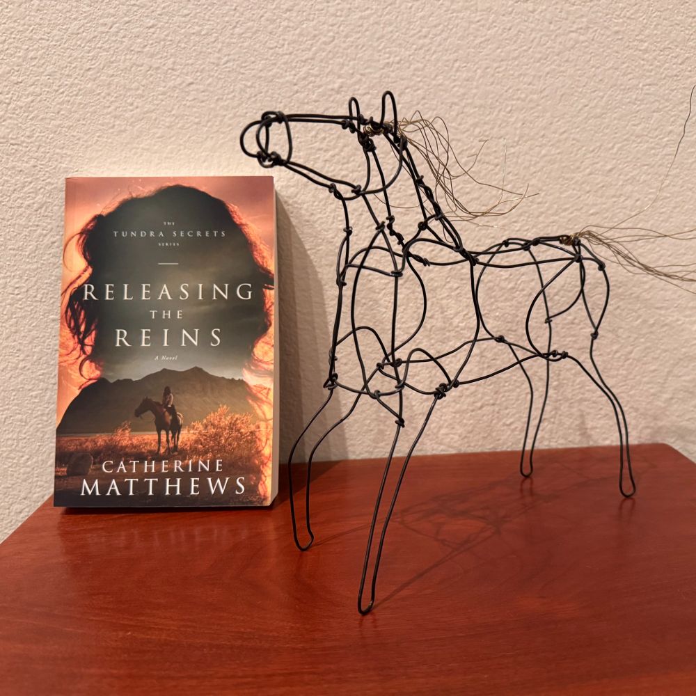 Photo of a horse sculpture and the cover of Catherine Matthew's novel, Releasing the Reins.