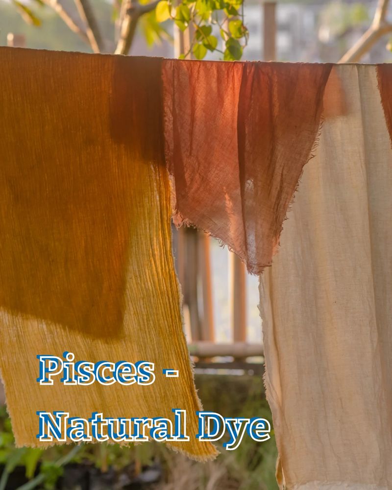 Gauzy cotton fabrics on a clothesline, each is dyed a different amber or orange color. Text: Pisces - natural dye