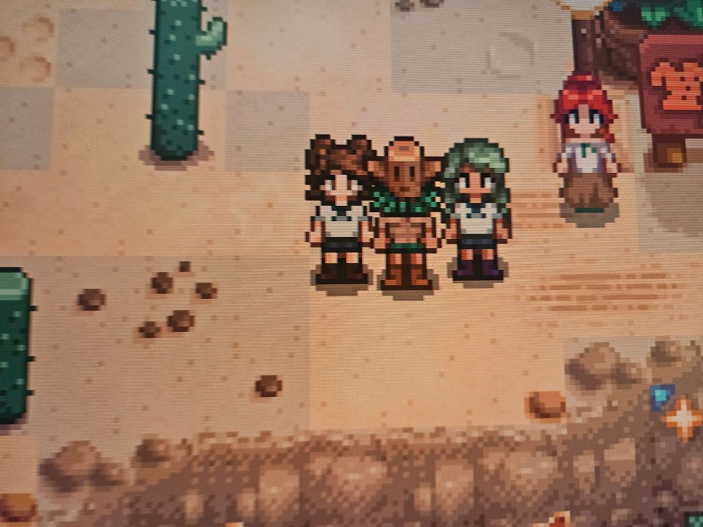 Lyrae and Bailey are in little school/sailor uniforms, and Marzo has on a Farm Totem mask, a muscle shirt, and a grass skirt.