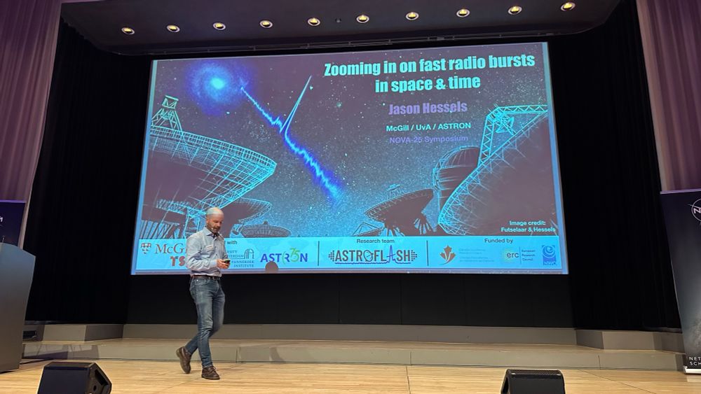 Jason Hessels walks in front of a slide with radio dishes and a fast radio burst time series