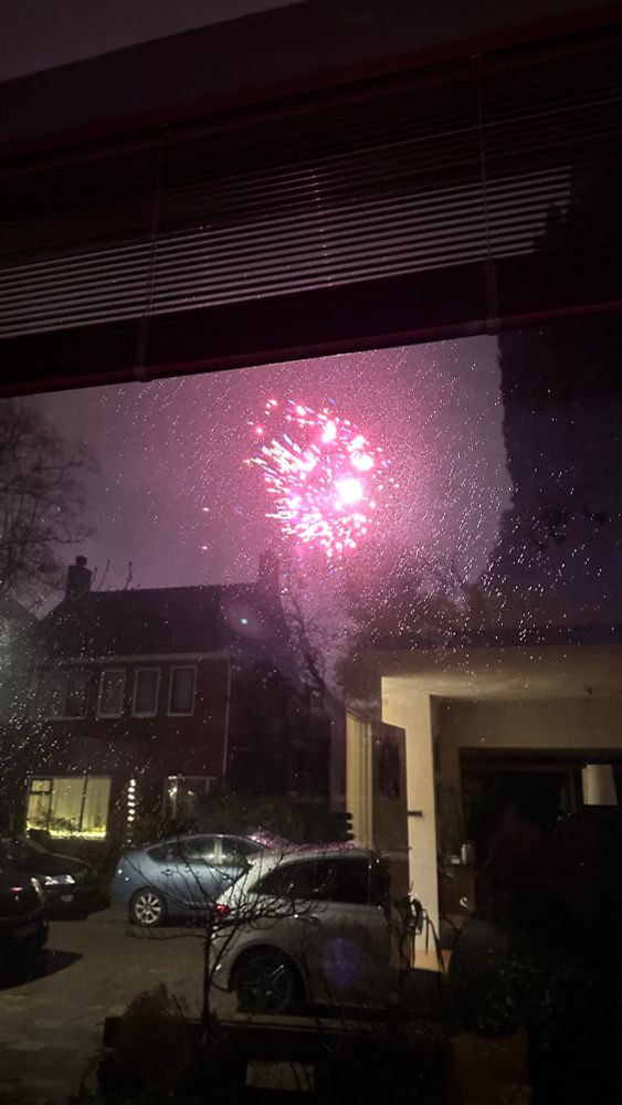 Fireworks through a rainy window. 