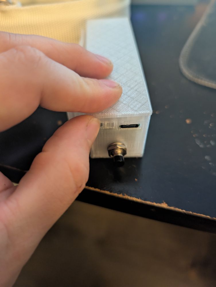 Close up drawing attention to the low profile slider on/off switch. 
Button and USB-C on the face of the controller. 