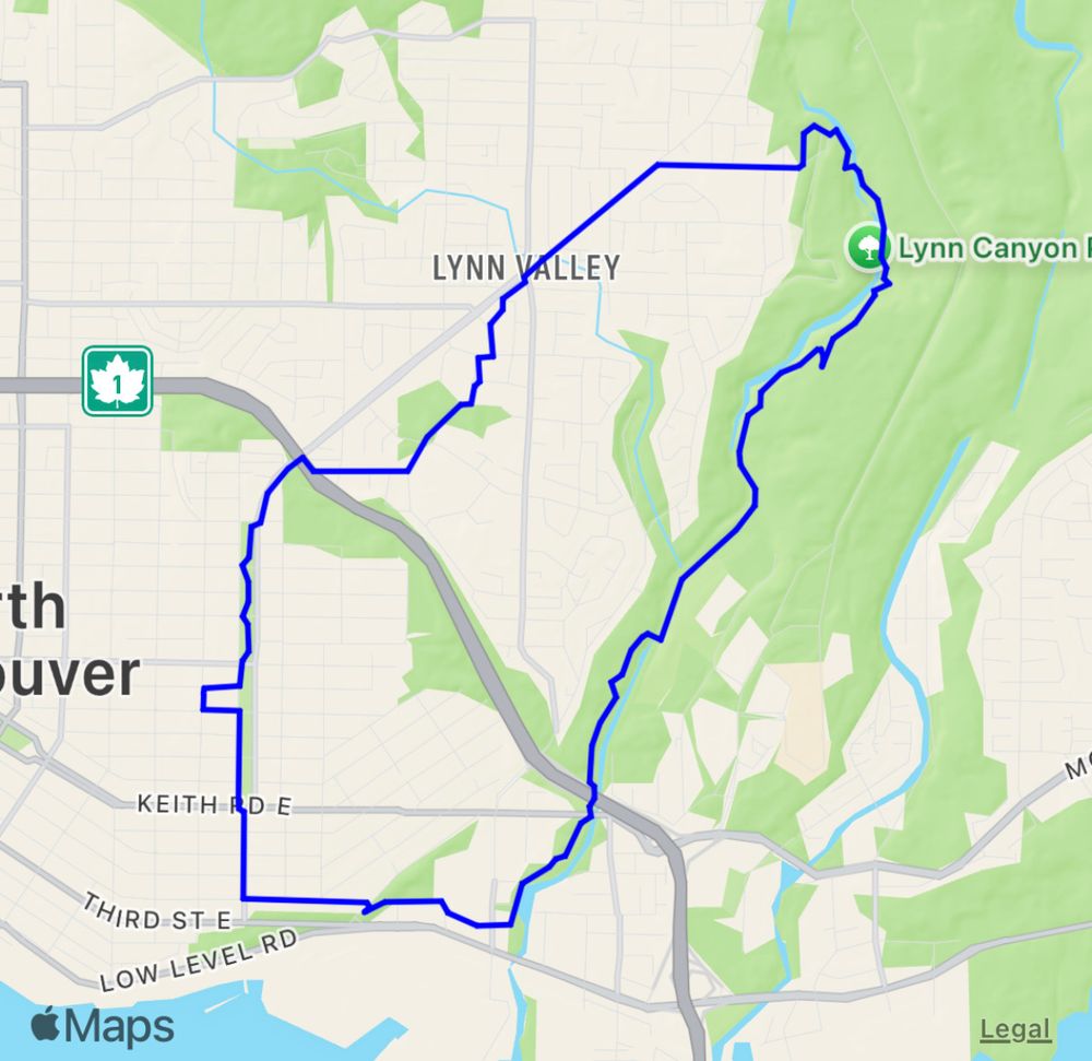 The image is a map showing a section of North Vancouver with a blue outlined route forming a large irregular loop. The route passes through neighbourhoods and green spaces, including the Lynn Valley area and Lynn Canyon Park.