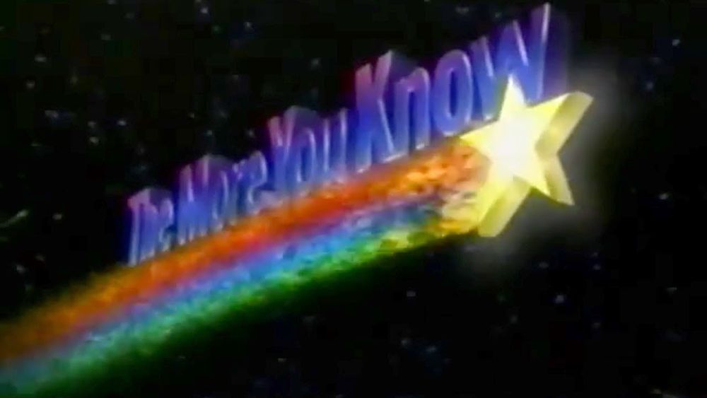 "The More You Know" in a cheesy word art font, on top of a shooting star with a tri-color rainbow tail behind it