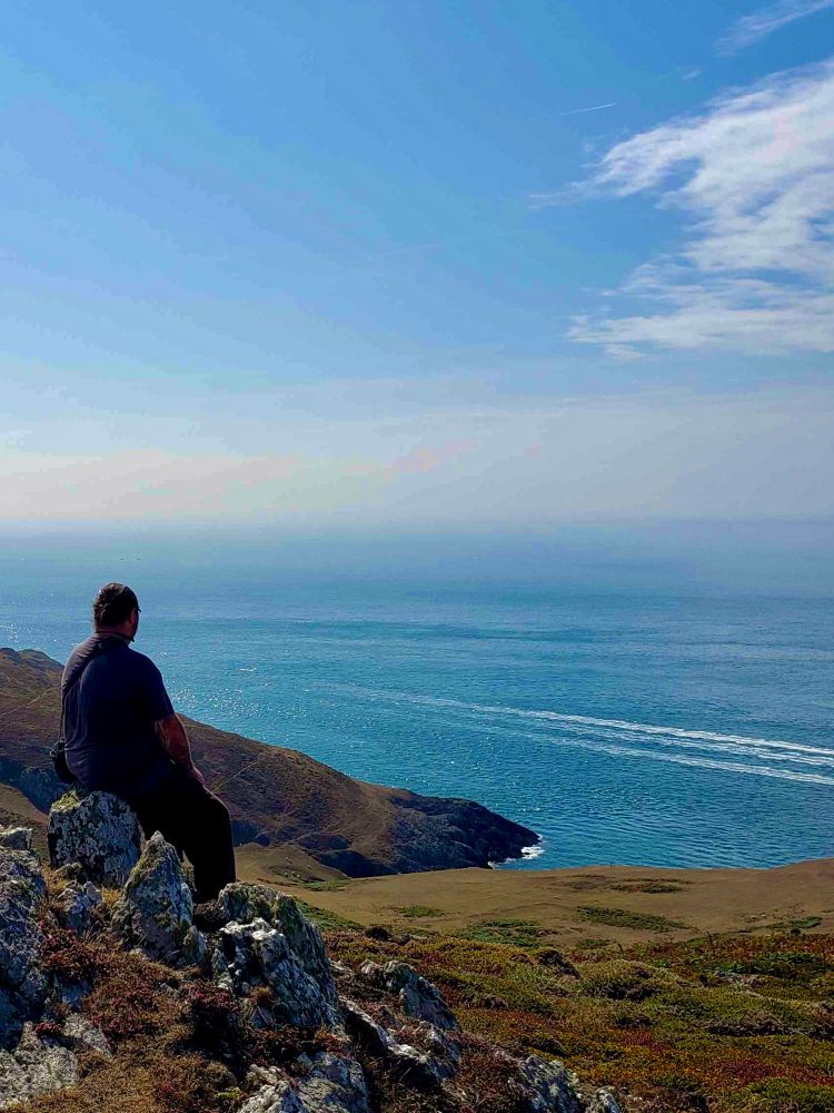 Me, on rocks, looking out over the sea