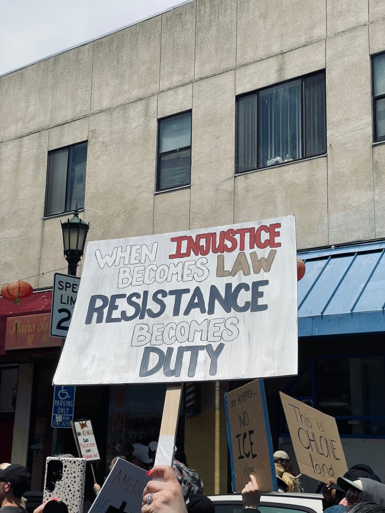 protest sign saying “when injustice becomes law resistance becomes duty”