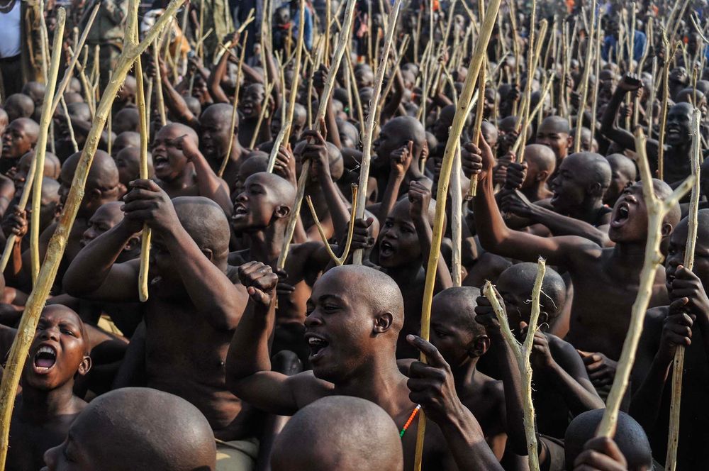 Initiates cheer as they return home after undergoing the koma rite of passage in Moletjie, Limpopo province, on July 19, 2025. The traditional practice, which includes circumcision for boys and men, is a key event on the cultural calendar. Girls also take part in separate initiation programmes focused on preparing them for womanhood. Since June, 529 initiation schools have been registered in Limpopo, with more than 25,000 initiates. Officials say the province recorded the lowest fatality rate in the country this season, with two deaths linked to medical conditions, including epilepsy. (Photo by LUCAS LEDWABA / AFP)