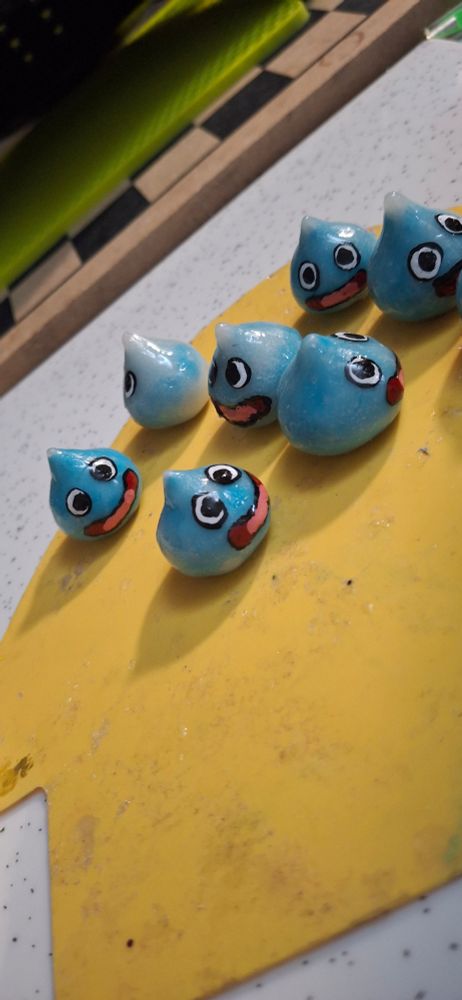A bunch of polymer clay Slimes done with a shiny resin finish.