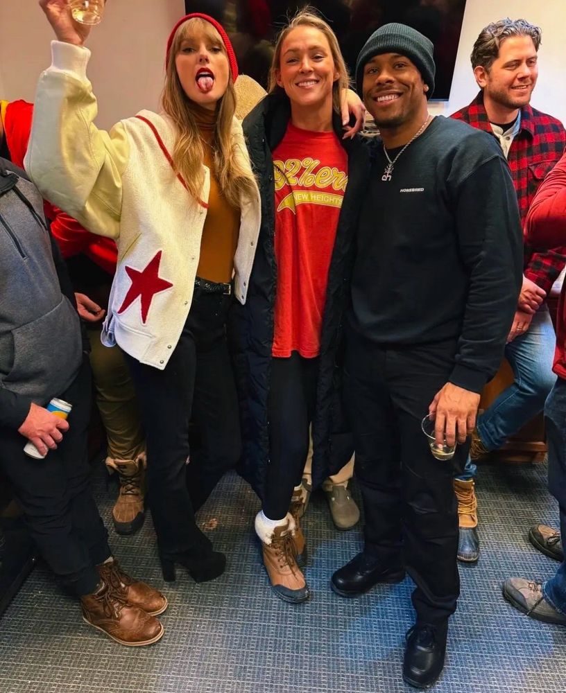 A picture of Taylor, Aric and Kylie wearing a chiefs-themed 92%er t-shirt