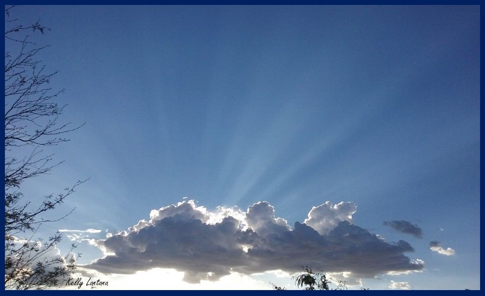 Quote is from an antique book of devotions, “Streams in the Desert” (Vol. 2)… Seen on a recent desert evening, a small gathering of clouds, in various hues of grey, blue, white. The sun, descending behind the clouds, sends resolute lovely white rays, gracefully fanning outward above the clouds. Gentle, peaceful, and strong.