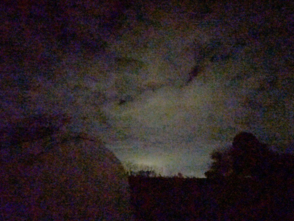 Cloudy sky at night with my observatory in the foreground