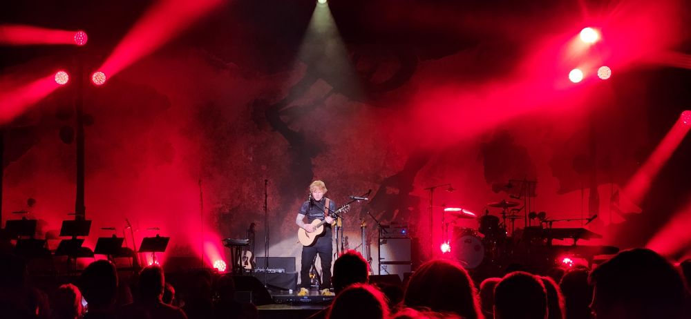Ed Sheeran performing on stage with a guitar