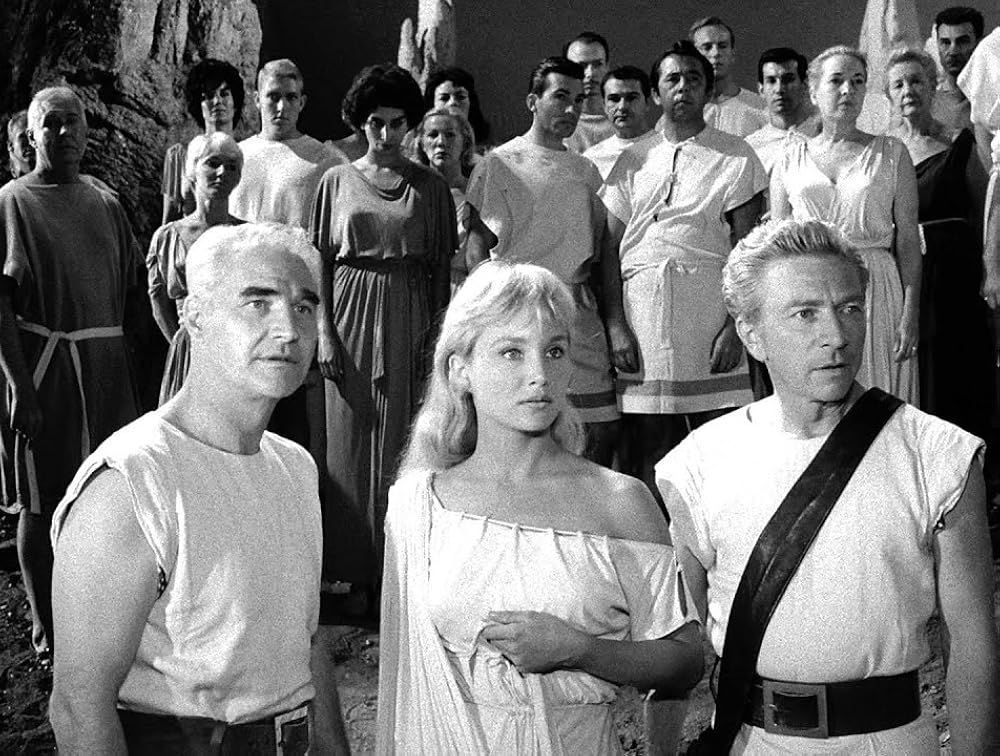 A screen capture from the episode of The Twilight Zone called "People Are Alike All Over". Vic Perrin is the male Martian in the front right.