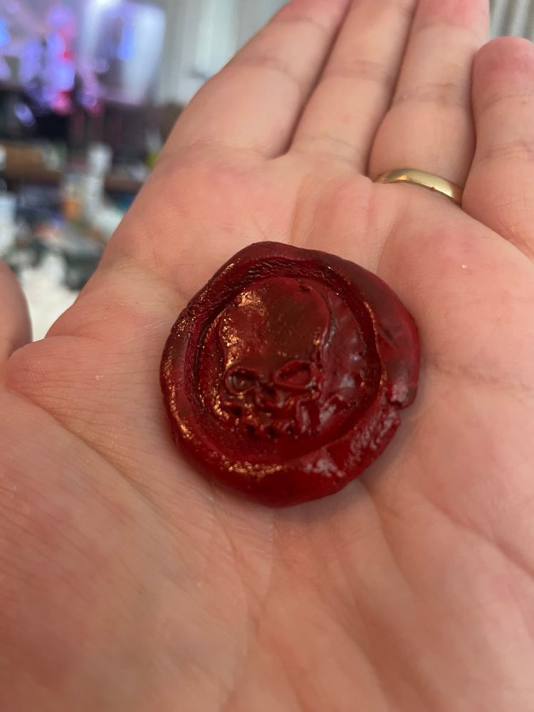 A Warhammer 40K purity seal (without ribbons/parchment) made out of milliput