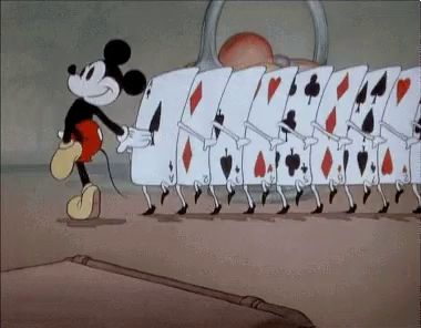 a cartoon of mickey mouse carrying a row of playing cards