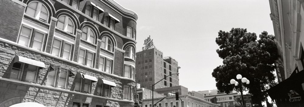 A black and white panoramic image of buildings in the Gaslamp District in San Diego. 