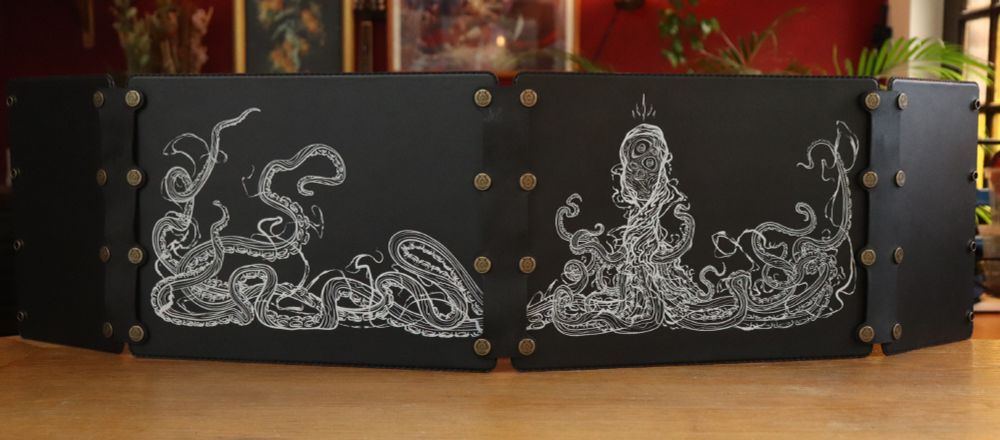A black leather DM screen made up out of 4 panels, depicting a mass of tentacles coming out of a cloak.