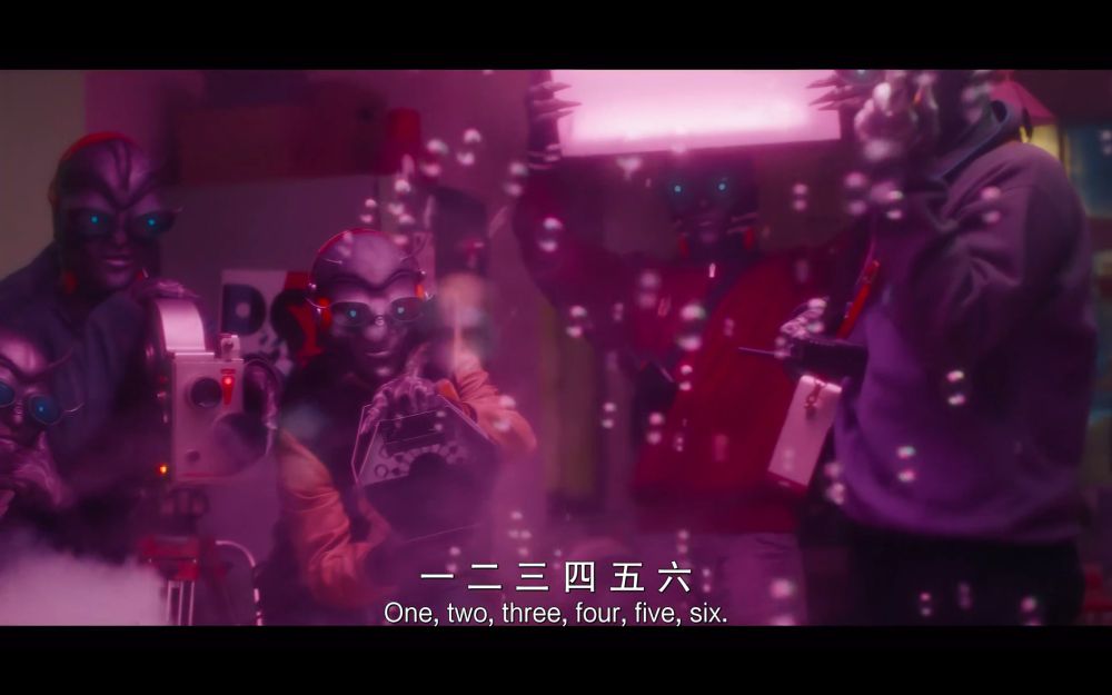 The camera cuts to a group of grey aliens with bright blue eyes filming them and making bubbles appear using a bubble machine. She counts them to prove she can see them too, "One, two, three, four, five, six (...)" 