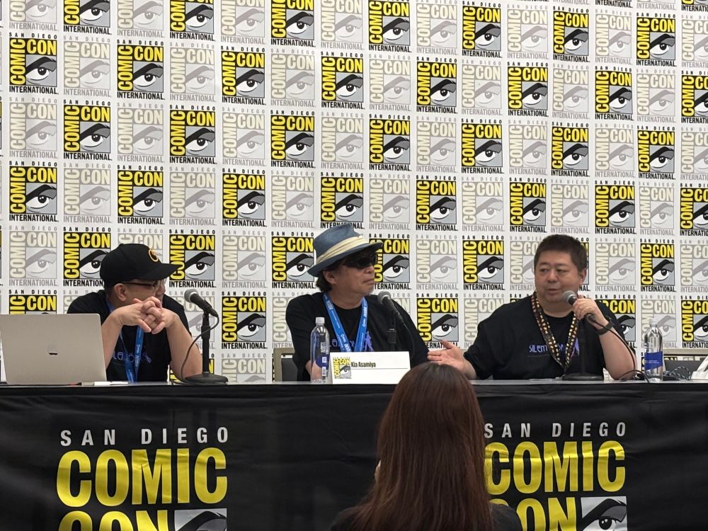 Three men on a panel - one is Kia Asamiya, the mangaka for Slient Mobius and many other works 