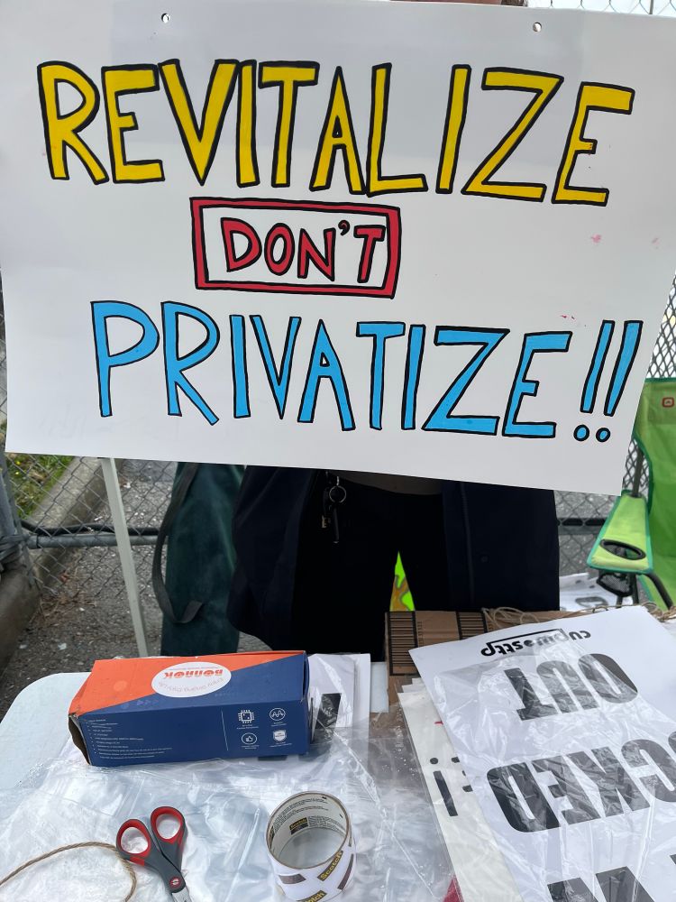 Protest sign on the line: revitalize don’t privatize!