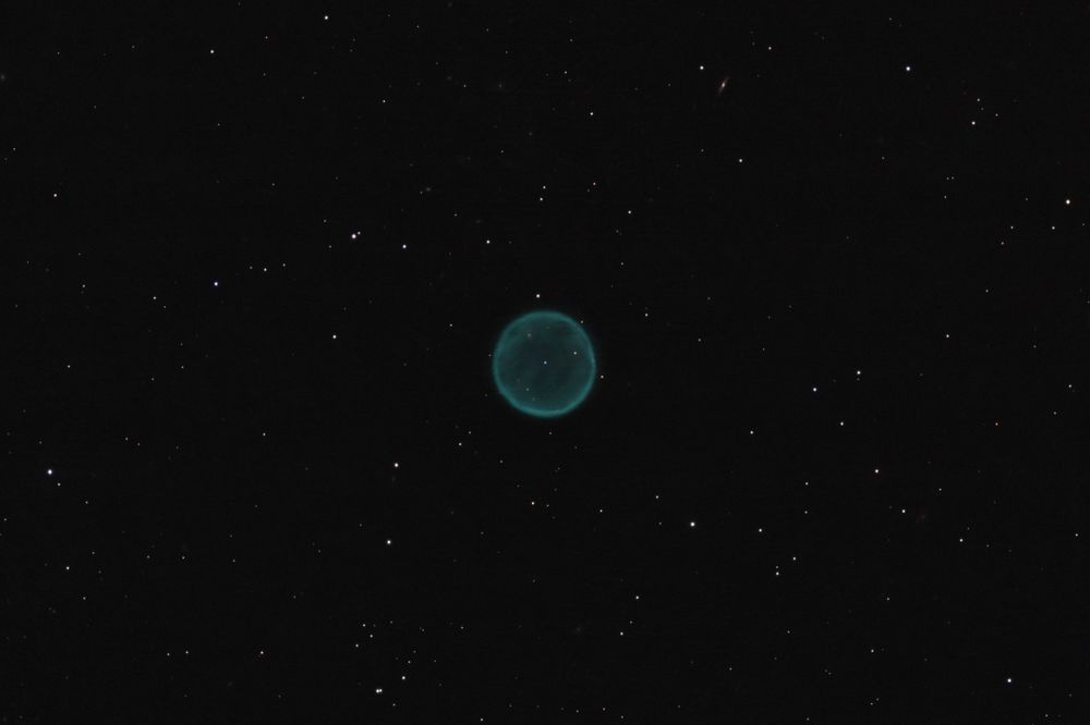 Abell 39 is a faint planetary nebula about 3800 light years away from Earth in the constellation of Hercules. Its shell has a radius of about 1.4 light years and has a nearly perfect spherical shape. It looks like a bubble in space!